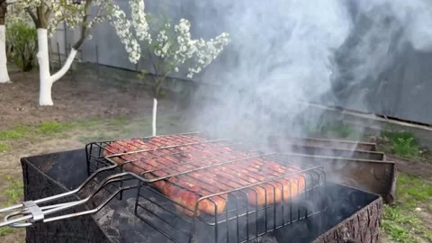 In the spring, sausages are grilled at the dacha Stock Footage 239766202