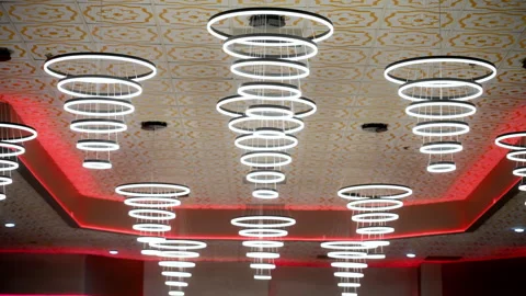 The spring shape decor lamp hanging on the ceiling inside the celebration hall Video stock 314589329