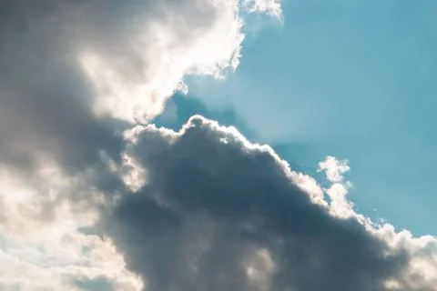 Spring sky. clouds covering the sun and beams peering under them Stock Photos
