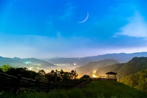 Spring sky symphony: The charming crescent moon hangs in the sky. Stock Photos