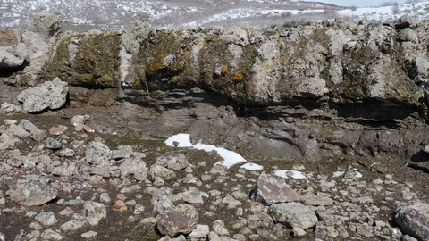 Spring snow melting over rocks in the mountians Stock Footage 105936248