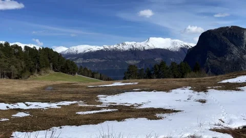 Spring snowy field among the mountains and fjords Video stock 309140982