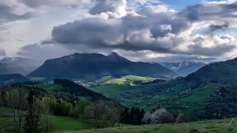 Spring storm clouds rolling over lush green mountain valley timelapse with Stock-Footage 322687944