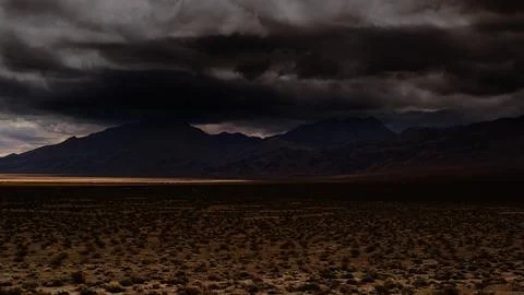 Spring storms brew, dark and foreboding, over Death Valley. Stock Photos