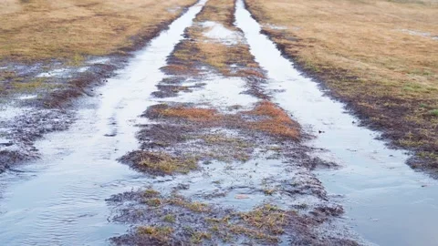 Spring streams flow. A dirty rural road. Snow melting. Spring. Stock Footage 270268965