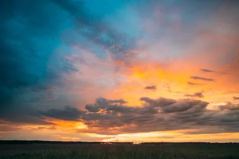Spring Summer Meadow At Evening Sunset Sunrise. Natural Bright Dramatic Sky In Stock Photos