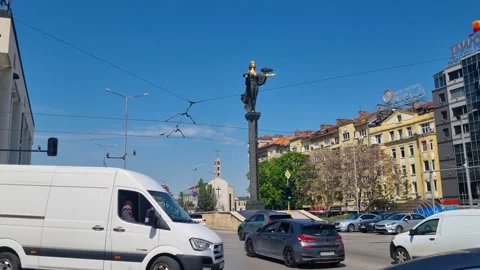Spring sunlight illuminates central Sofia as cars pass under the iconic Saint Stock Footage 316135929