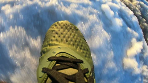 Spring . Sunset. A man strolls along the snowy road. Footwear. Legs . Stock Footage 88663914