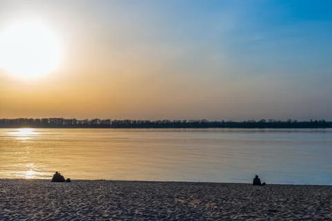 Spring sunset in warm colors on the river bank Stock Photos