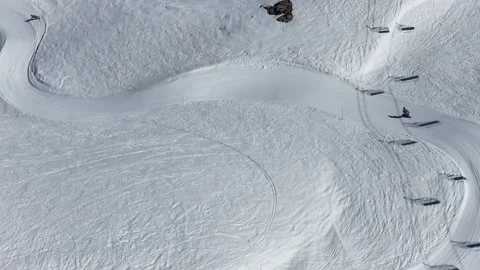 Spring sunshine over Val d'Isere ski resort in the French Alps, snowboarder.. Stock Footage 335371078