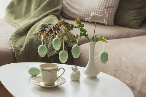 Spring Table Decor with Bunny Figurines, Hanging Eggs and Floral Cup of Coffe Stock Photos