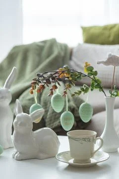Spring Table Decor with Bunny Figurines, Hanging Eggs and Floral Cup of Coffe Stock Photos