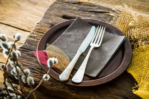 Spring table setting. Cutley on wood. Fork and knife in plate. Flatlay overhe Stock Photos