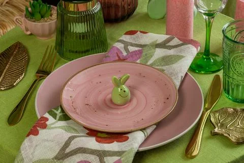 Spring table setting for Easter in pink and green. Stock Photos