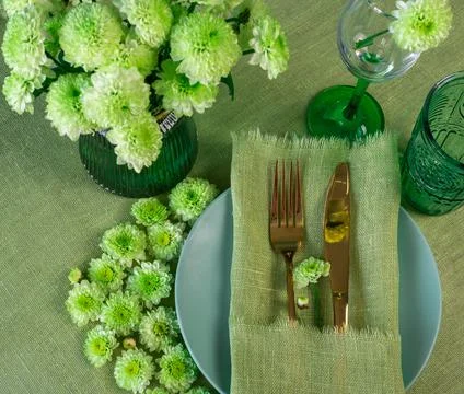 Spring table setting in green tone with flowers Stock Photos
