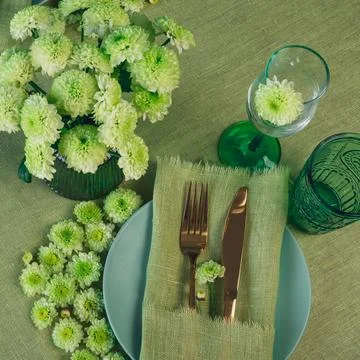 Spring table setting in green tone with flowers Stock Photos