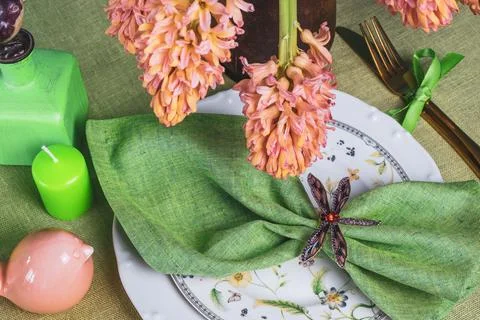 Spring table setting with hyacinths on a green linen tablecloth Stock Photos