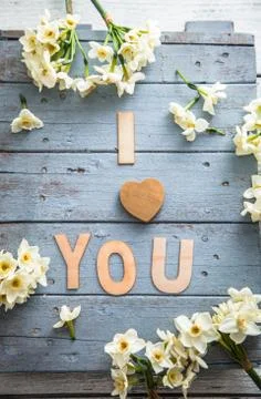 Spring table setting. Narcissus flower. Fork on Easter table. I love you lett Stock Photos