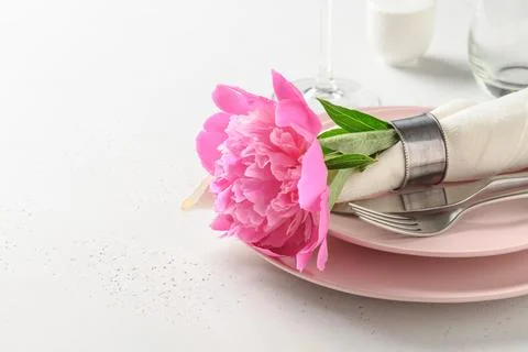 Spring table setting with pink peony flowers on a white table. View from abov Stock Photos