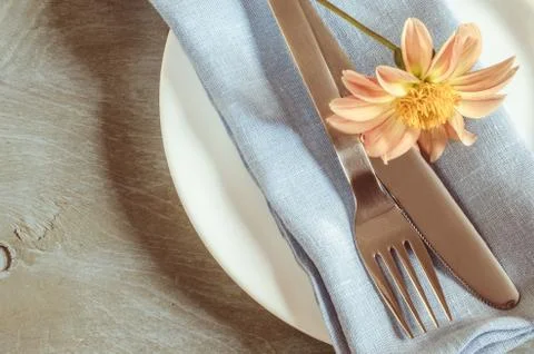 Spring table settings with fresh flower, napkin and silverware. Stock Photos