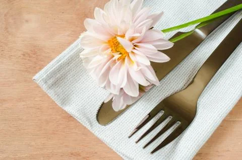 Spring table settings with fresh flower, napkin and silverware. Stock Photos