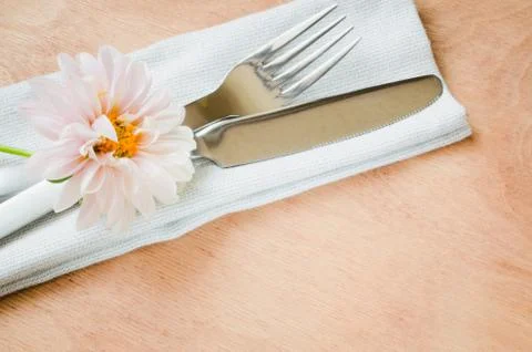 Spring table settings with fresh flower, napkin and silverware. Stock Photos
