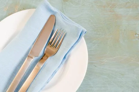 Spring table settings with fresh flower, napkin and silverware. Stock Photos
