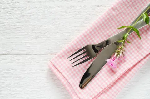 Spring table settings with fresh flower, napkin and silverware. Stock Photos