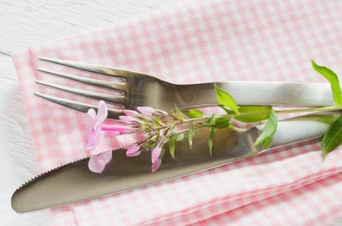 Spring table settings with fresh flower, napkin and silverware. Stock Photos