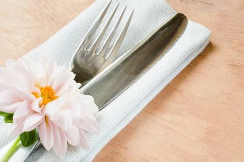 Spring table settings with fresh flower, napkin and silverware. Stock Photos