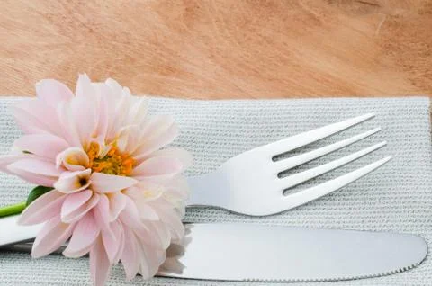 Spring table settings with fresh flower, napkin and silverware. Stock Photos