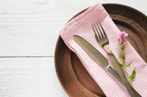 Spring table settings with fresh flower, napkin and silverware. Stock Photos