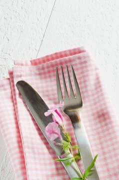 Spring table settings with fresh flower, napkin and silverware. Stock Photos