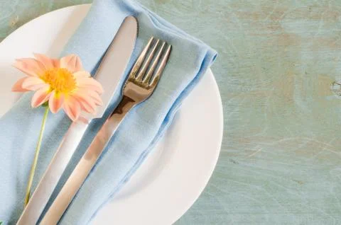 Spring table settings with fresh flower, napkin and silverware. Stock Photos