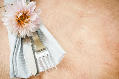 Spring table settings with fresh flower, napkin and silverware. Stock Photos
