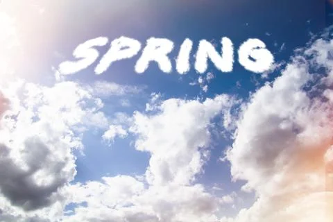 Spring. Text from clouds in sky in bright sunlight. Stock Photos