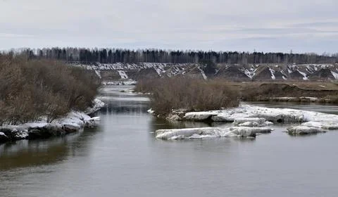Spring thawed patches in the fields, the Sylva river is slowly freed from ice Stock Photos