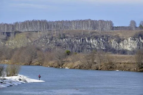 Spring thawed patches in the fields, the Sylva river is slowly freed from ice Stock Photos