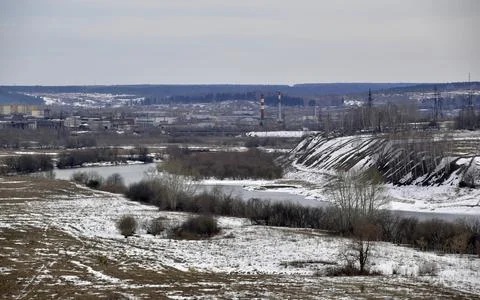Spring thawed patches in the fields, the Sylva river is slowly freed from ice Stock Photos