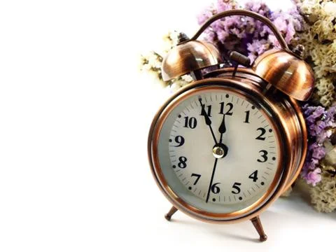 Spring time with alarm clock and statice flowers bouquet background 库存照片