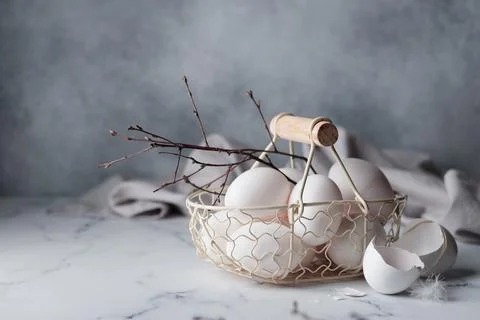 Spring time, easter holidays, white eggs in a basket Stock Photos