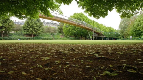 A spring time lapse view of the paris reuilly paul pernin garden and bridge Stock Footage 133530255