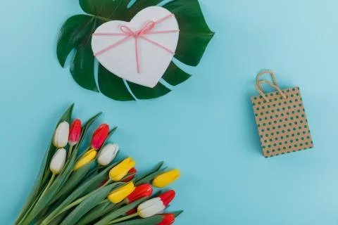 Spring tulips frame on background, top view. Postcard for Women's Day. Stock Photos