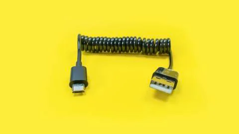 Spring twisted wire on a yellow background Foto stock