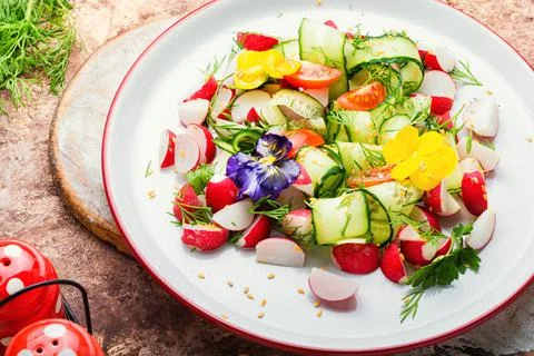Spring vegetable salad with flowers Stock Photos
