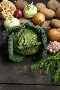 Spring vegetables on a dark background: Savoy cabbage, cauliflower, onion Foto stock