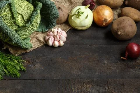 Spring vegetables on a dark background: Savoy cabbage, cauliflower, onion Stock Photos