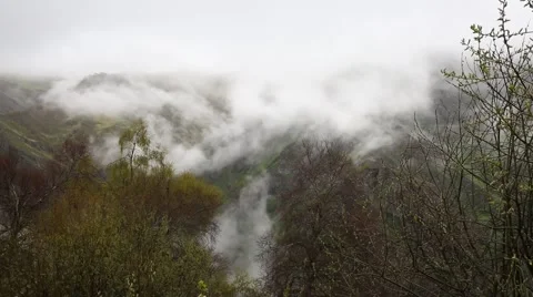In spring the veil of mist creeping up the mountain slopes of the Caucasus Stock Footage 63222979