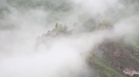 In spring the veil of mist creeping up the mountain slopes of the Caucasus 動画素材 63223278