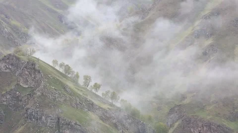 In spring the veil of mist creeping up the mountain slopes of the Caucasus Vídeos de archivo 63223490